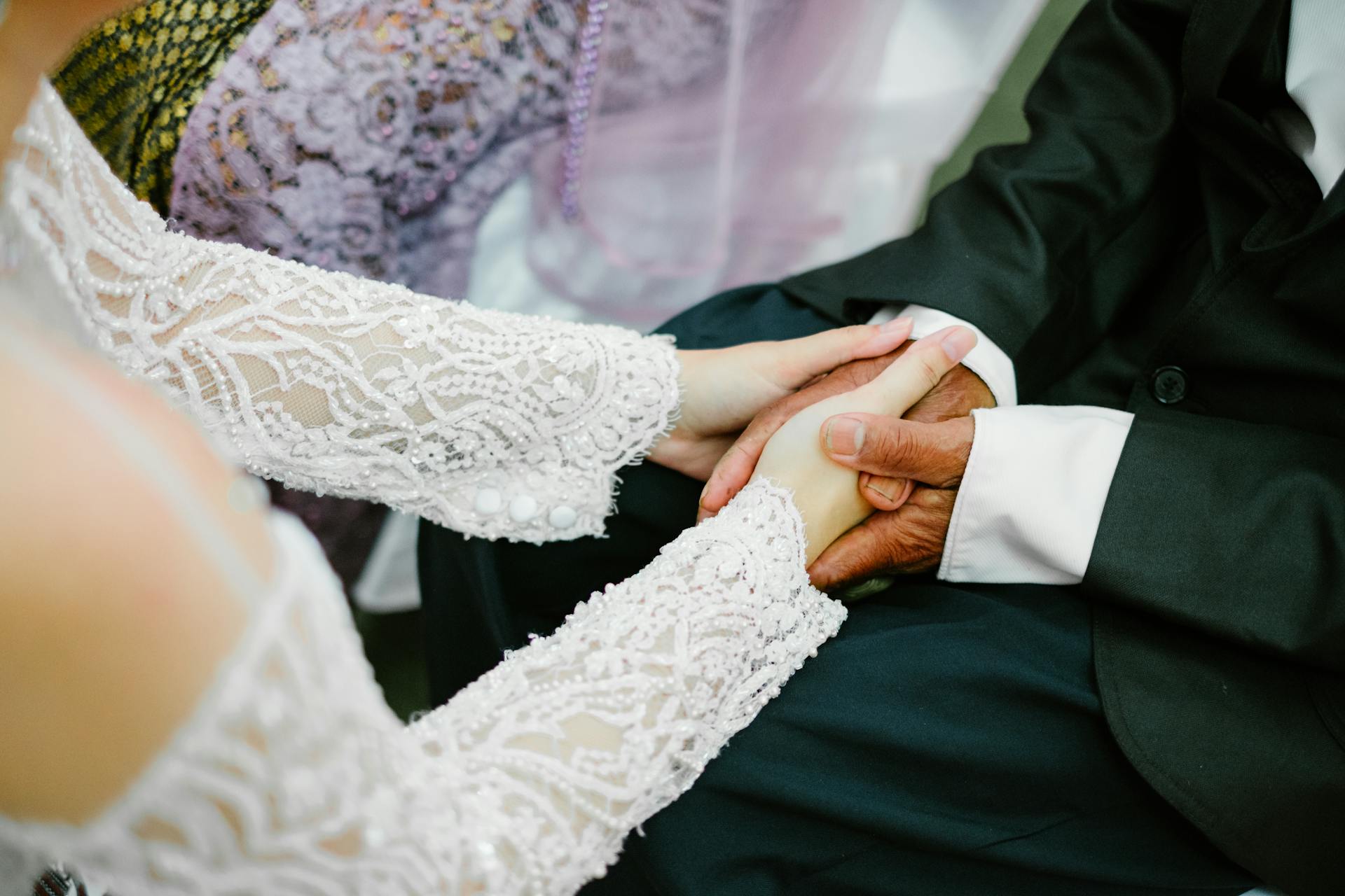 Photo by Febry Arya: https://www.pexels.com/photo/bride-holding-hands-with-a-parent-19847701/